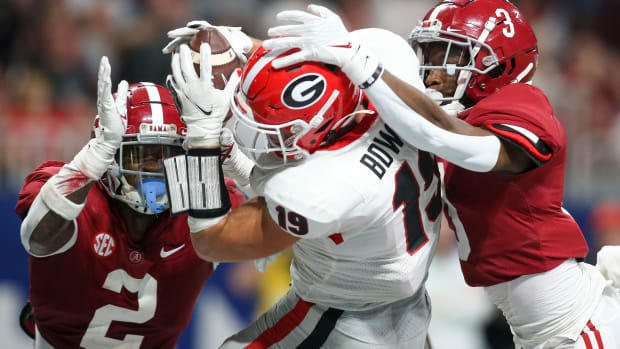Dec 4, 2021; Atlanta, GA, USA; Georgia Bulldogs tight end Brock Bowers (19) has a reception broken up by Alabama Crimson Tide defensive back DeMarcco Hellams (2) and defensive back Daniel Wright (3) in the second half during the SEC championship game at Mercedes-Benz Stadium.